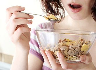 Image showing Young people eating milk with cereals