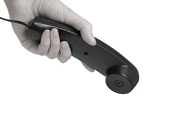 Image showing office black telephone with hand dialing. 
