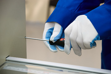 Image showing A screwdriver in glove hand