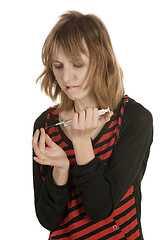 Image showing girl pricks a finger a syringe