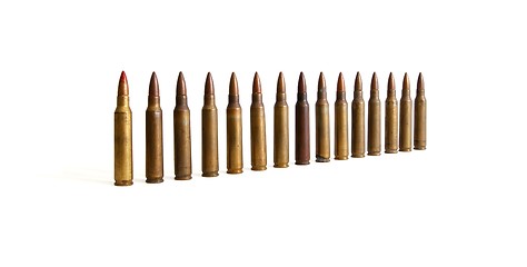 Image showing Row of standing M16 cartridges converging in perspective isolated