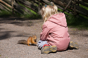 Image showing little girl plays with the squirrel
