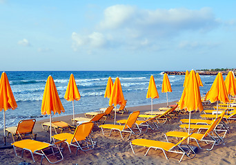 Image showing Sunbeds and beach umbrellas