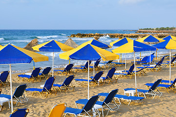 Image showing Sunbeds and beach umbrellas