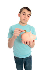 Image showing Boy saving coins for a rainy day