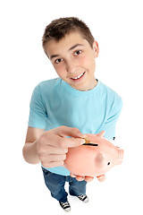 Image showing Saving pennies in a piggy bank