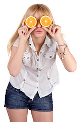 Image showing Portrait of the funny girl with oranges. Isolated