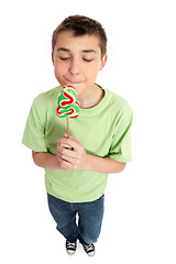 Image showing Boy holding a sweet yummy Christmas candy