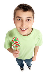 Image showing Happy boy holding a lollipop candy