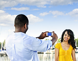 Image showing Woman posing for picture near boats