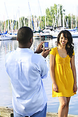 Image showing Woman posing for picture near boats