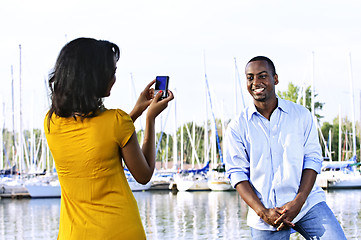 Image showing Man posing for picture near boats
