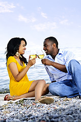 Image showing Happy couple having wine on beach