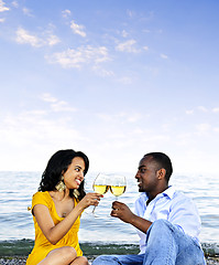 Image showing Happy couple having wine on beach