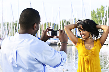 Image showing Woman posing for picture near boats