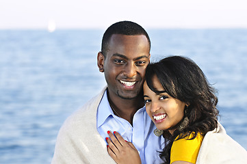 Image showing Happy couple sharing blanket