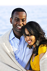 Image showing Happy couple sharing blanket