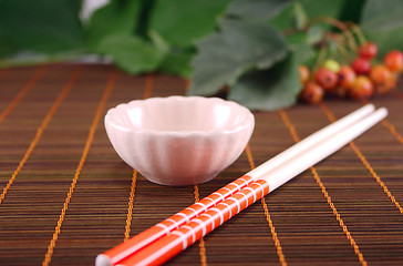 Image showing Cup and chopstick