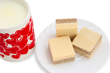 Image showing Ceramic mug with milk and a white saucer with wafers