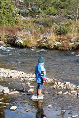 Image showing Boy standing by the river
