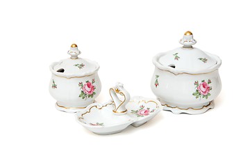 Image showing Two white porcelain sugar basins and double jam dish with roses isolated