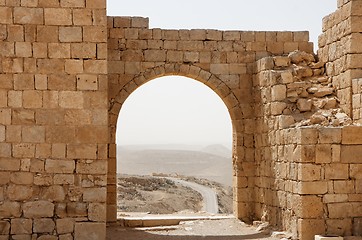 Image showing Ancient stone arch and wall with desert view during sandstorm