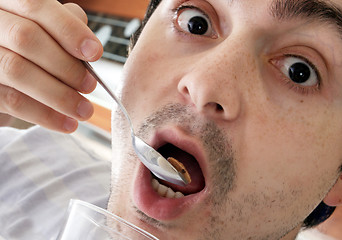 Image showing Young people eating milk with cereals