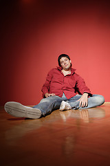 Image showing sexy young man on red background