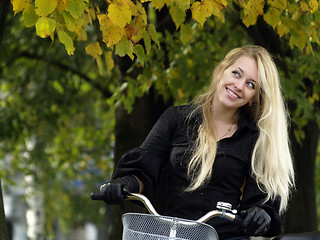 Image showing Young woman on bicylce