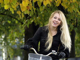 Image showing Young woman on bicylce