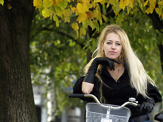 Image showing Young woman on bicylce