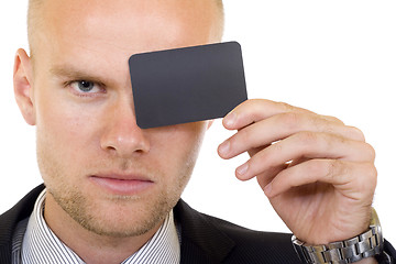 Image showing Young businessman with blank card in his hand