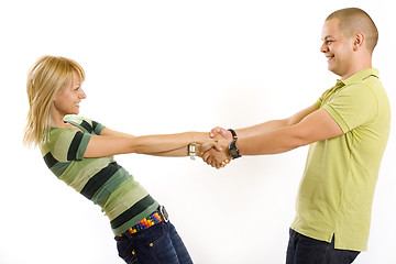 Image showing happy young couple holding by hands