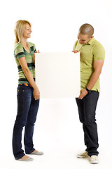 Image showing young couple presenting a blank board 