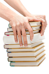 Image showing Feminine hands keeps pile of the books