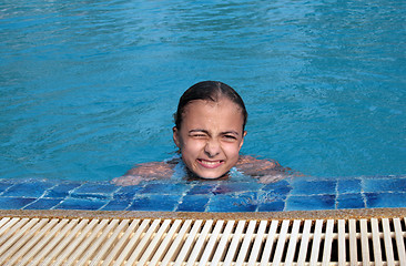 Image showing Beautiful girl in pool with blue water