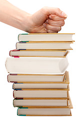 Image showing Feminine fist on pile of the books