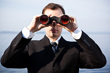 Image showing Caucasian businessman with binoculars