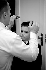 Image showing Father Helping Son Get Ready