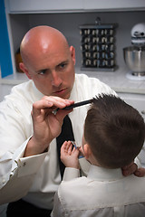 Image showing Father Helping Son Get Ready