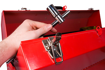 Image showing Hand removing a wrench from a toolbox