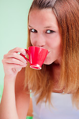 Image showing Redhead woman drinking coffee