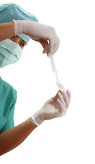 Image showing Hands filling a syringe