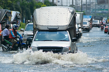 Image showing Flooded street with trucks and cars