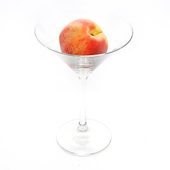 Image showing The fresh peach in the martini glass isolated on white backgroun