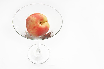 Image showing The fresh peach in the martini glass isolated on white backgroun