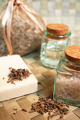 Image showing Natural soap, bottles of essential oil and sea salt, dry lavende