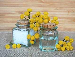 Image showing Bottles of essential oil and sea salt in spa composition