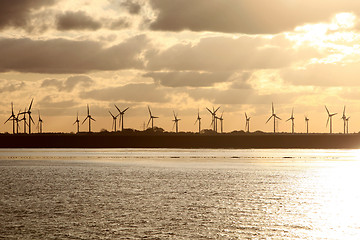 Image showing Wind turbines at sunrise or sunset on the sea