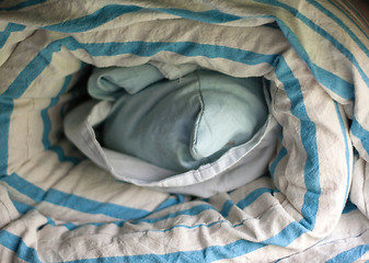 Image showing Roll of dirty bedclothes